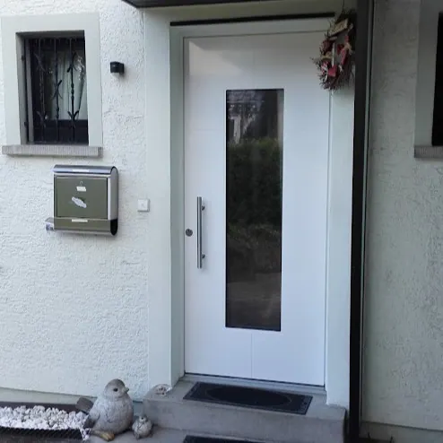 Weiße Haustür mit schlankem Lichtausschnitt und Vordach